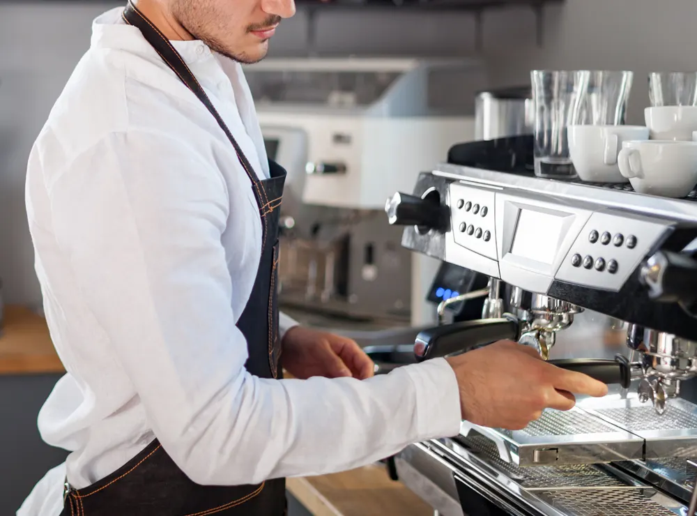 Barista working at a professional espresso machine